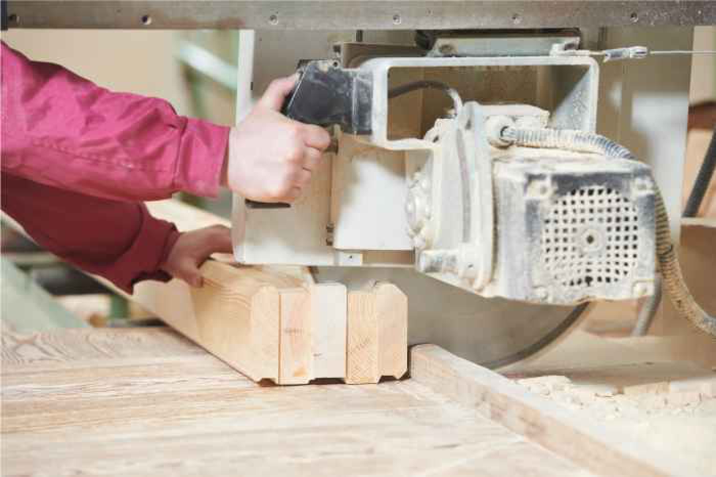 Cut-off saw being pulled through multiple 2x4 lumber